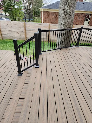 Composite deck with black aluminum railing and gate, built around a mature tree, Louisville KY